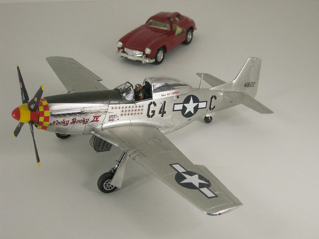 studio light photo of P-51D Mustang airplane and Mercedes Benz car